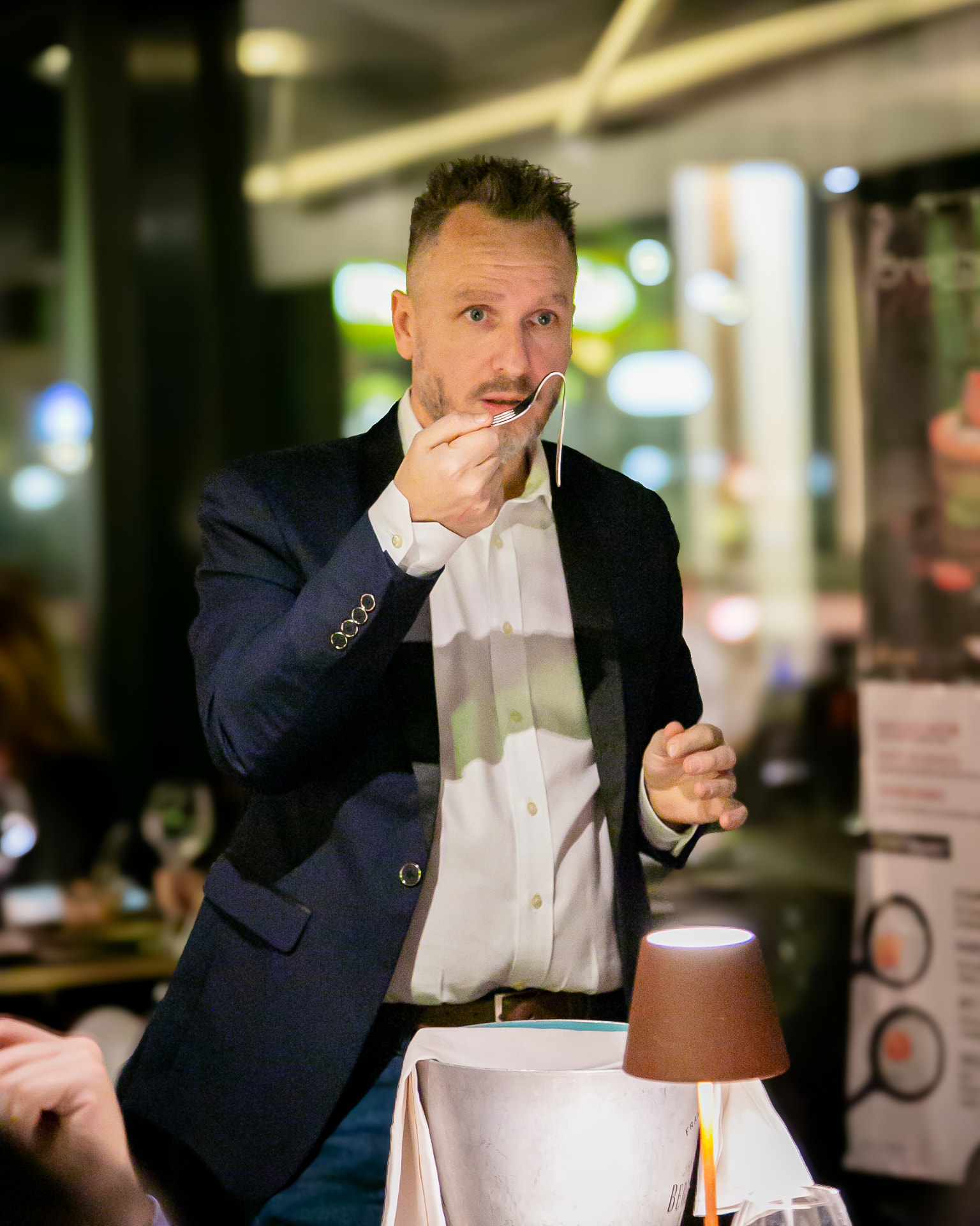 Silvano Frigerio piega una forchetta durante un evento a cena
